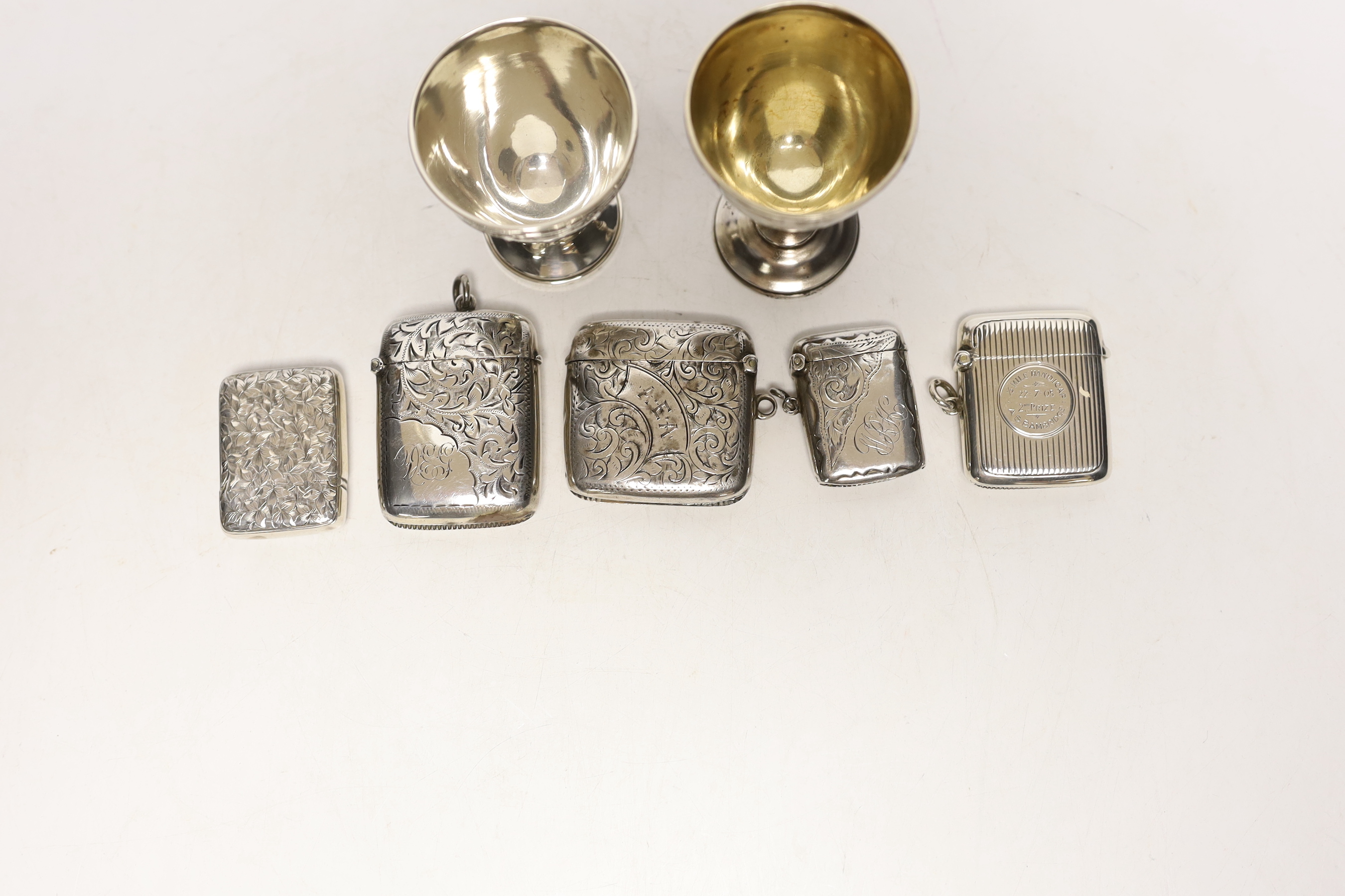 An early 20th century Russian 84 zolotnik egg cup, 69mm a later silver egg cup and five assorted silver vesta cases.